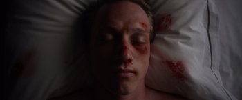 Movie still from “Shelter in Place” (2021), directed by Connor Martin – A person's face covered in blood; Close Up shot, Overhead angle