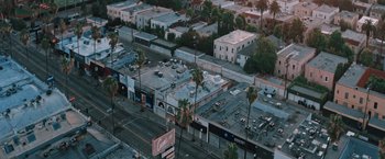Movie still from “Shelter in Place” (2021), directed by Connor Martin – An aerial view of an intersection in a large city; Extreme Wide shot, High angle