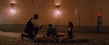 Movie still from “Shelter in Place” (2021), directed by Connor Martin – A group of people sitting around a room; Wide shot, High angle