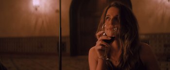 Movie still from “Shelter in Place” (2021), directed by Connor Martin – A beautiful woman holding a glass of red wine; Medium shot, Low angle