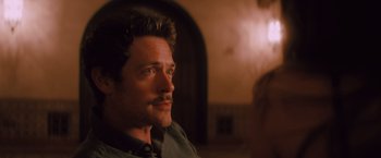 Movie still from “Shelter in Place” (2021), directed by Connor Martin – A person with a beard and mustache; Close Up shot, Over the shoulder angle