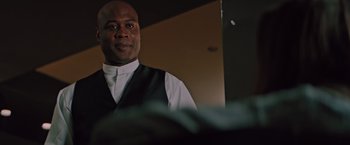 Movie still from “Shelter in Place” (2021), directed by Connor Martin – A man wearing a white shirt and a black vest; Close Up shot, Low angle