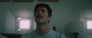 Movie still from “Shelter in Place” (2021), directed by Connor Martin – A person with a mustache; Close Up shot, Low angle