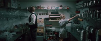 Movie still from “Shelter in Place” (2021), directed by Connor Martin – A man and a woman are in a kitchen; Medium shot, Low angle