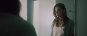 Movie still from “Shelter in Place” (2021), directed by Connor Martin – A woman standing in front of a bathroom mirror; Close Up shot, Over the shoulder angle