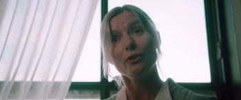 Movie still from “Shelter in Place” (2021), directed by Connor Martin – A person looking at the camera; Close Up shot, Low angle