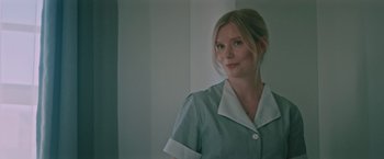 Movie still from “Shelter in Place” (2021), directed by Connor Martin – A woman in a green and white uniform; Close Up shot, Low angle
