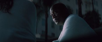 Movie still from “Shelter in Place” (2021), directed by Connor Martin – A man with a towel around his neck looks into the distance; Close Up shot, Over the shoulder angle