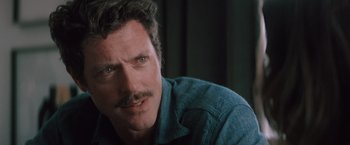 Movie still from “Shelter in Place” (2021), directed by Connor Martin – A person with a mustache; Close Up shot, Over the shoulder angle