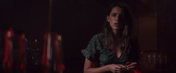 Movie still from “Shelter in Place” (2021), directed by Connor Martin – A woman sitting in front of a red lamp; Close Up shot, Over the shoulder angle