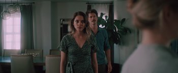 Movie still from “Shelter in Place” (2021), directed by Connor Martin – A man and a woman standing next to each other in front of a mirror; Medium shot, Low angle