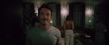 Movie still from “Shelter in Place” (2021), directed by Connor Martin – A man and a woman in a living room; Close Up shot, Low angle