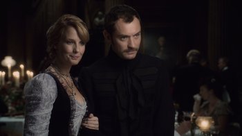 Movie still from “Sherlock Holmes” (2009), directed by Guy Ritchie – A man and a woman standing next to each other; Medium shot, Over the shoulder angle