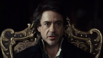 Movie still from “Sherlock Holmes” (2009), directed by Guy Ritchie – A person sitting in a chair; Close Up shot, High angle