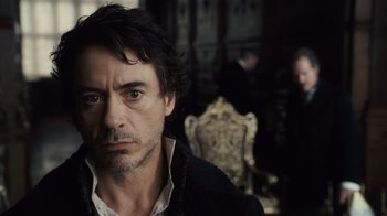 Movie still from “Sherlock Holmes” (2009), directed by Guy Ritchie – A person with a beard; Close Up shot, Over the shoulder angle