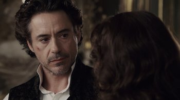 Movie still from “Sherlock Holmes” (2009), directed by Guy Ritchie – A person talking to another person; Close Up shot, Over the shoulder angle