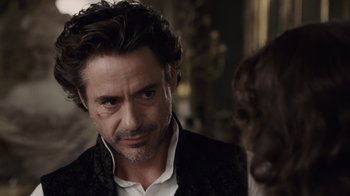 Movie still from “Sherlock Holmes” (2009), directed by Guy Ritchie – A person wearing a suit and tie; Close Up shot, Over the shoulder angle