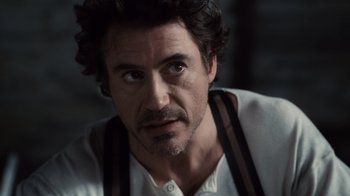 Movie still from “Sherlock Holmes” (2009), directed by Guy Ritchie – A person with a beard; Close Up shot, Over the shoulder angle