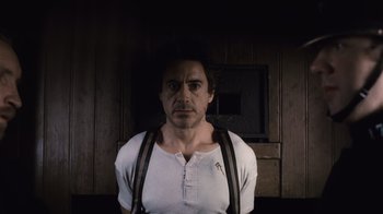 Movie still from “Sherlock Holmes” (2009), directed by Guy Ritchie – A person wearing suspenders; Medium shot, Low angle