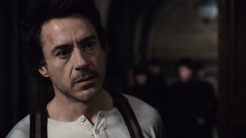 Movie still from “Sherlock Holmes” (2009), directed by Guy Ritchie – A person wearing a shirt; Close Up shot, Over the shoulder angle