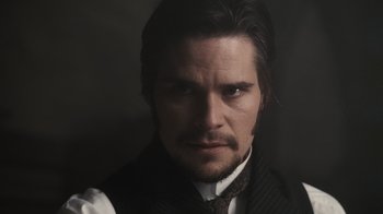 Movie still from “Sherlock Holmes” (2009), directed by Guy Ritchie – A person wearing a vest and a tie; Close Up shot, Low angle