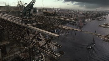 Movie still from “Sherlock Holmes” (2009), directed by Guy Ritchie – An aerial view of an industrial area with a crane; Extreme Wide shot, High angle