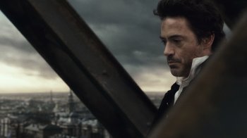 Movie still from “Sherlock Holmes” (2009), directed by Guy Ritchie – A person wearing a suit and tie; Close Up shot, Low angle