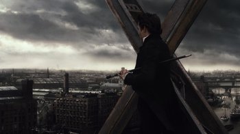 Movie still from “Sherlock Holmes” (2009), directed by Guy Ritchie – A man standing on the side of a building holding a pair of chopsticks; Wide shot, Over the shoulder angle