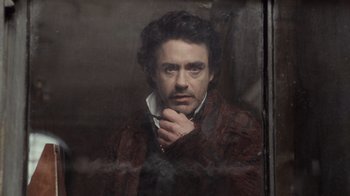 Movie still from “Sherlock Holmes” (2009), directed by Guy Ritchie – A painting of a man with a beard and a mustache; Close Up shot, Low angle