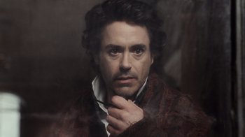 Movie still from “Sherlock Holmes” (2009), directed by Guy Ritchie – A painting of a man with a beard and mustache; Close Up shot, Low angle