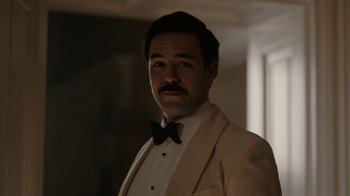 Movie still from “Bohemian Rhapsody” (2018), directed by Bryan Singer – A man wearing a tuxedo and a bow tie; Close Up shot, Low angle