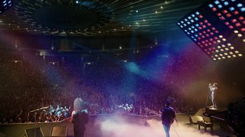 Movie still from “Bohemian Rhapsody” (2018), directed by Bryan Singer – Two people are performing in front of an audience; Extreme Wide shot, High angle