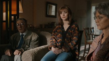 Movie still from “Bohemian Rhapsody” (2018), directed by Bryan Singer – A woman sitting on a chair in a living room; Medium shot, Over the shoulder angle