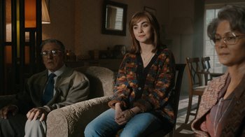 Movie still from “Bohemian Rhapsody” (2018), directed by Bryan Singer – A woman sitting on a chair next to an older man; Medium shot, Over the shoulder angle
