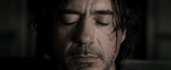 Movie still from “Sherlock Holmes: A Game of Shadows” (2011), directed by Guy Ritchie – A person with his eyes closed; Close Up shot, High angle