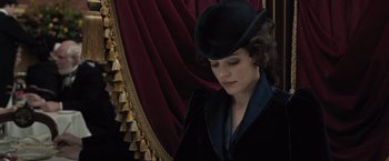 Movie still from “Sherlock Holmes: A Game of Shadows” (2011), directed by Guy Ritchie – A woman wearing a black hat and a black jacket; Close Up shot, Low angle