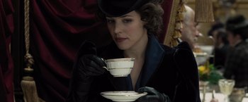 Movie still from “Sherlock Holmes: A Game of Shadows” (2011), directed by Guy Ritchie – A woman wearing gloves and holding a cup of tea; Close Up shot, Low angle