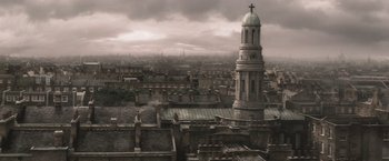 Movie still from “Sherlock Holmes: A Game of Shadows” (2011), directed by Guy Ritchie – An image of an old town with a clock tower in the middle of the city; Extreme Wide shot, High angle