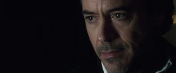 Movie still from “Sherlock Holmes: A Game of Shadows” (2011), directed by Guy Ritchie – A man's face in the dark; Close Up shot, Over the shoulder angle