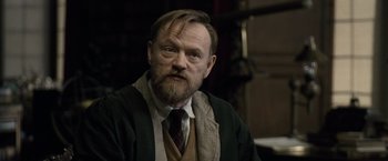 Movie still from “Sherlock Holmes: A Game of Shadows” (2011), directed by Guy Ritchie – An older man with a beard and a mustache; Medium shot, Over the shoulder angle