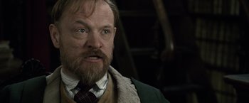 Movie still from “Sherlock Holmes: A Game of Shadows” (2011), directed by Guy Ritchie – A person with a beard wearing a jacket; Close Up shot, Low angle