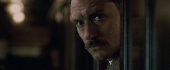 Movie still from “Sherlock Holmes: A Game of Shadows” (2011), directed by Guy Ritchie – A person with a mustache; Close Up shot, Over the shoulder angle