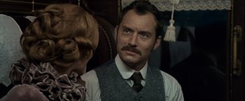Movie still from “Sherlock Holmes: A Game of Shadows” (2011), directed by Guy Ritchie – A man in a vest and tie looking into a mirror; Close Up shot, Over the shoulder angle