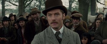Movie still from “Sherlock Holmes: A Game of Shadows” (2011), directed by Guy Ritchie – A man with a mustache wearing a hat; Close Up shot, Over the shoulder angle