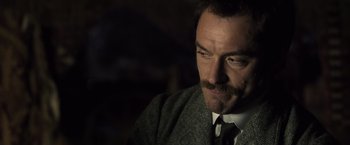 Movie still from “Sherlock Holmes: A Game of Shadows” (2011), directed by Guy Ritchie – A person wearing a suit and tie; Close Up shot, Over the shoulder angle