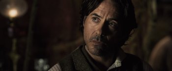 Movie still from “Sherlock Holmes: A Game of Shadows” (2011), directed by Guy Ritchie – A person wearing a vest; Close Up shot, Over the shoulder angle