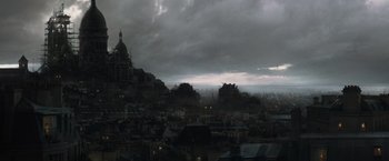Movie still from “Sherlock Holmes: A Game of Shadows” (2011), directed by Guy Ritchie – A view of a city from a distance with dark clouds; Extreme Wide shot, High angle