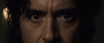 Movie still from “Sherlock Holmes: A Game of Shadows” (2011), directed by Guy Ritchie – A man's eyes and his face; Extreme Close Up shot, Overhead angle