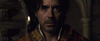 Movie still from “Sherlock Holmes: A Game of Shadows” (2011), directed by Guy Ritchie – A person wearing a suit; Close Up shot, Over the shoulder angle