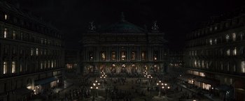 Movie still from “Sherlock Holmes: A Game of Shadows” (2011), directed by Guy Ritchie – An image of a night scene of a large building; Extreme Wide shot, High angle
